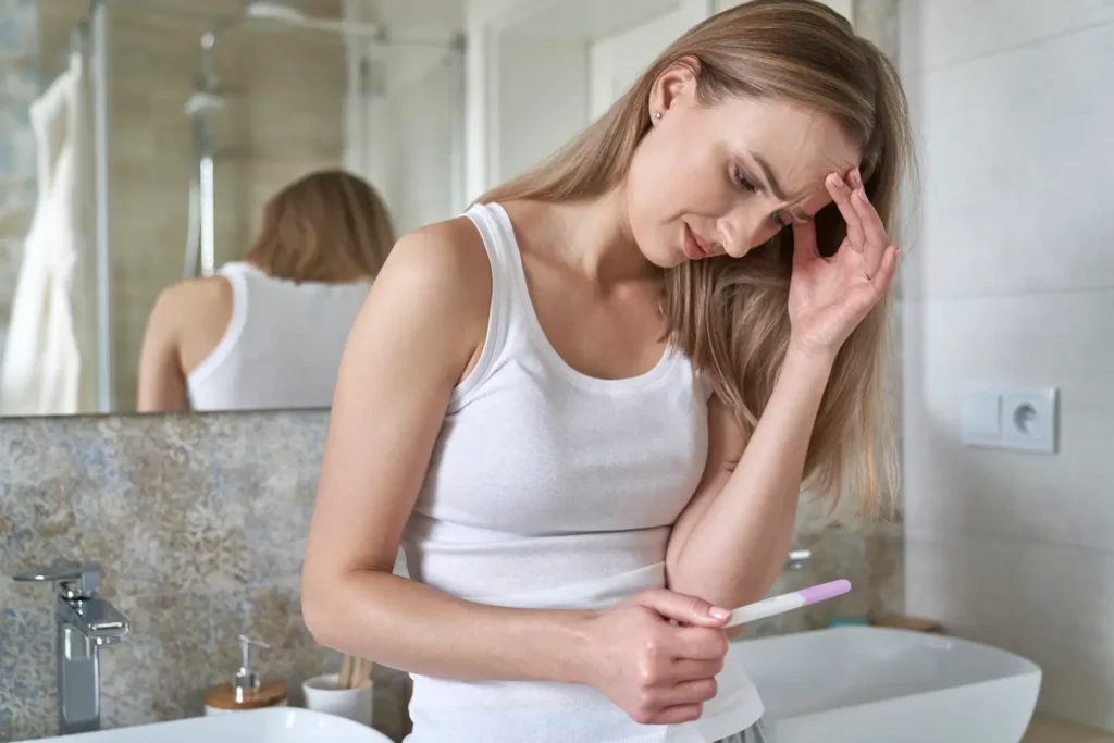 Mujer joven preocupada leyendo sobre infertilidad femenina-clinica de Femme